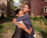 Couple embraces in yard near scene of domestic violence incident, Chicago, Illinois, 2000