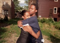 Couple embraces in yard near scene of domestic violence incident, Chicago, Illinois, 2000  thumbnail