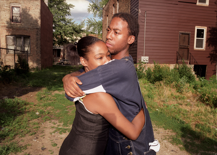 Couple embraces in yard near scene of domestic violence incident, Chicago, Illinois, 2000 